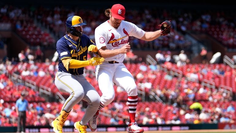 Milwaukee Brewers' Garrett Mitchell collides with St. Louis Cardinals starting...