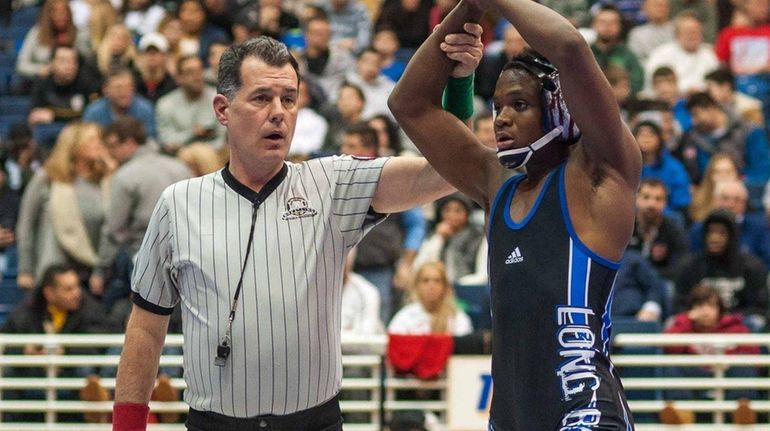 Long Beach's Jacori Teemer celebrates after winning the 126-pound final...