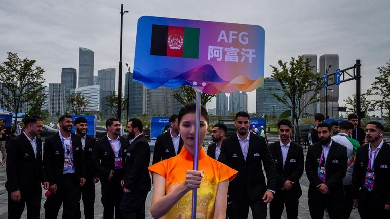 A volunteer holds up country's sign for Afghan men's only...