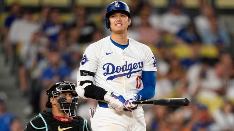 Los Angeles Dodgers designated hitter Shohei Ohtani reacts after a...