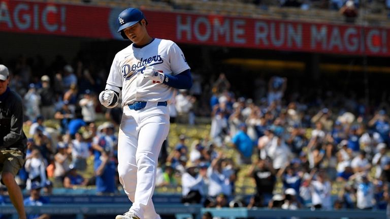 Los Angeles Dodgers' Shohei Ohtani scores after hitting a solo...