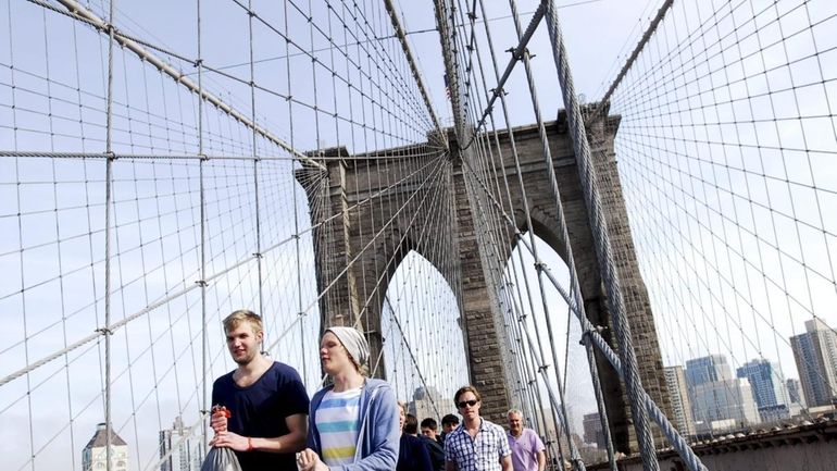 Pedestrians stroll on a warm day in early April over...