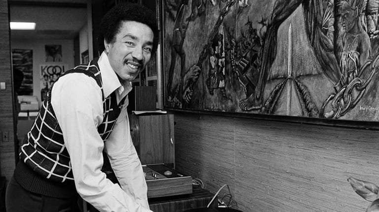 Smokey Robinson plays one of his hit records in his...