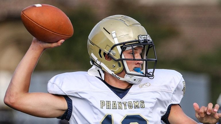 Bayport-Blue Point quarterback Brady Clark rolls out to pass during...