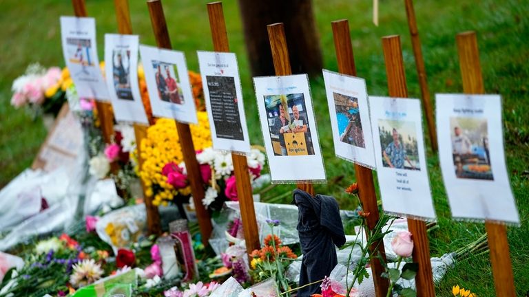 Rain-soaked memorials for those who died in a mass shooting...