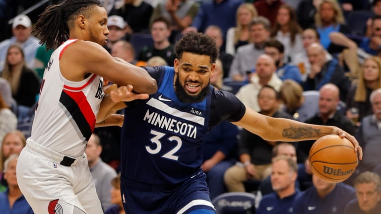 Minnesota Timberwolves forward Karl-Anthony Towns (32) goes to the basket...