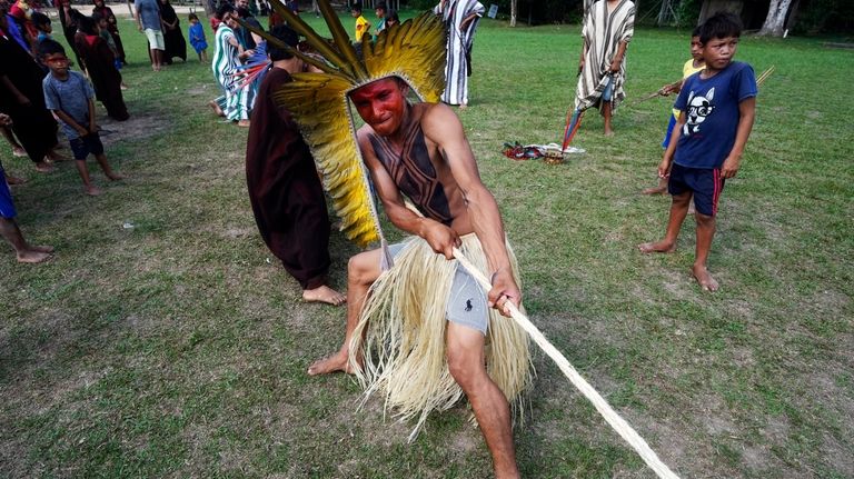 Charles Apolima participates in tug-of-war during the annual celebration recognizing...