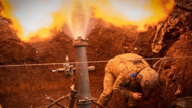 Ukrainian servicemen of the 28th Separate Mechanised Brigade fires a...