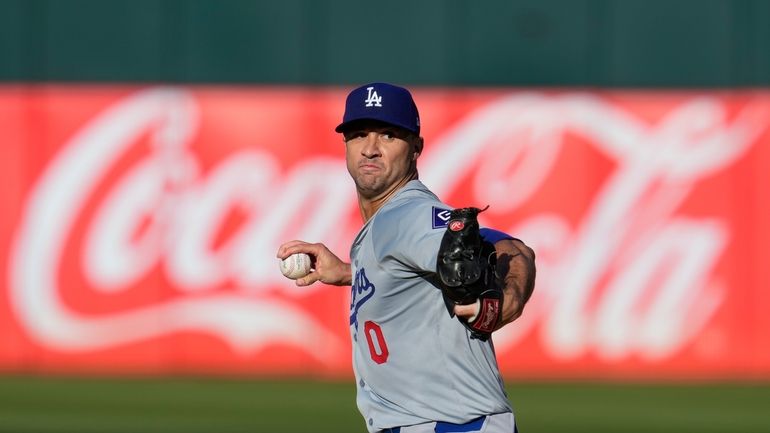 Los Angeles Dodgers pitcher Jack Flaherty throws to an Oakland...