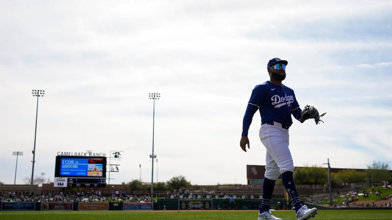 Los Angeles Dodgers center fielder Manuel Margot walks back to...