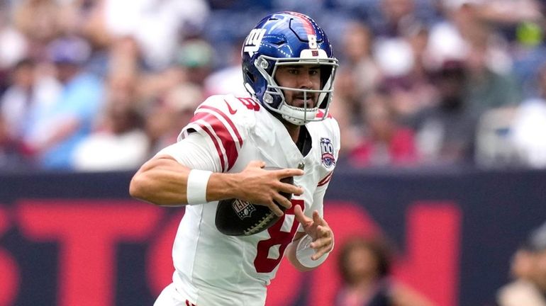 Giants quarterback Daniel Jones runs the ball in the first...