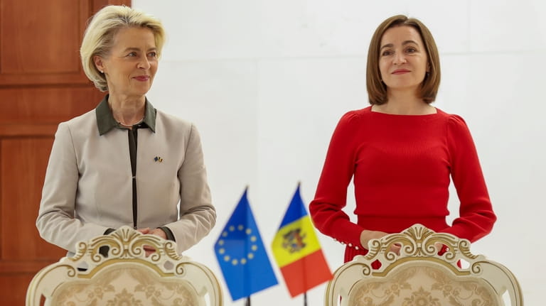 European Commission President Ursula von der Leyen, left, stands next...