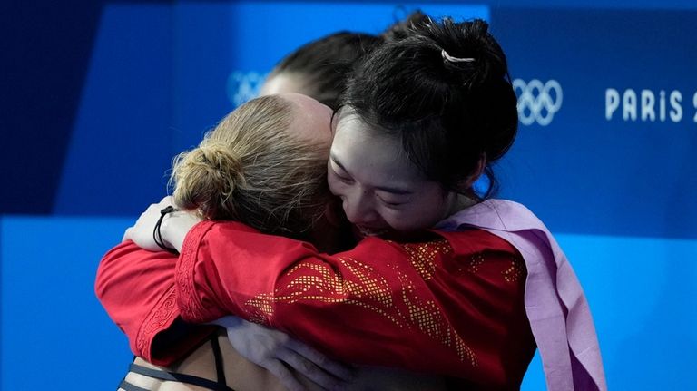 Chang Yani Hugh hut with United States' Sarah Bacon after...