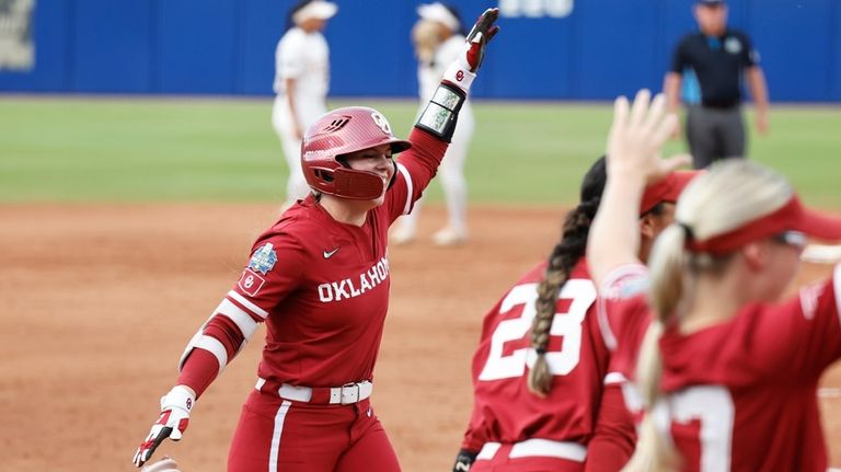 Oklahoma's Kasidi Pickering (7) celebrates her home run against Texas...