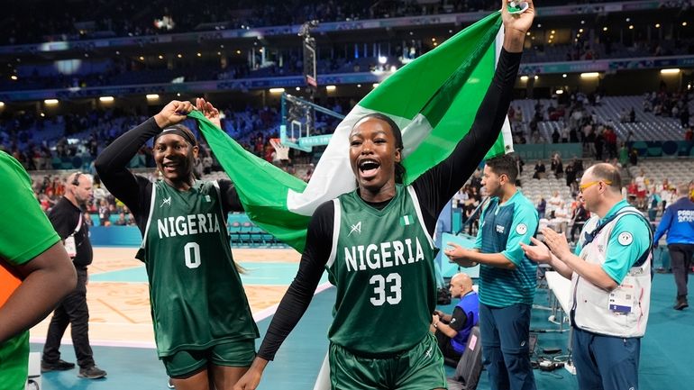 Nicole Enaosi (33) and Amy Okonkwo (0), of Nigeria, celebrate...