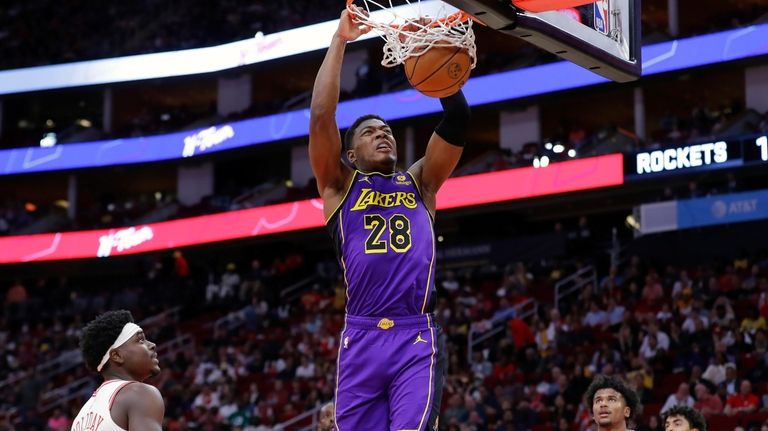 Los Angeles Lakers forward Rui Hachimura (28) dunks over Houston...