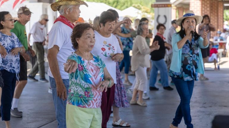 Annie Dent, in flower top, on the country line dance...