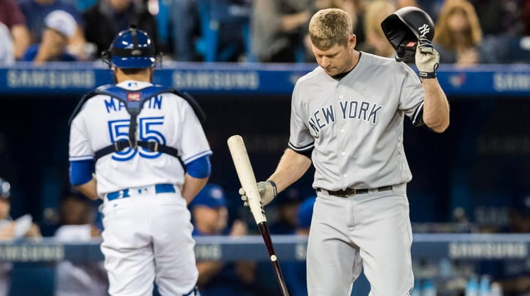 Yankees' Chase Headley reacts after striking out with the bases...