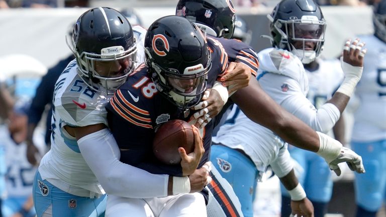 Tennessee Titans linebacker Harold Landry III, left, sacks Chicago Bears...