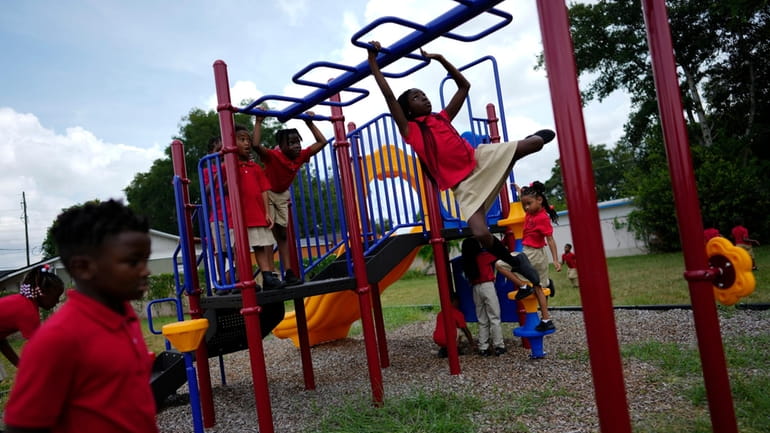 Students from Thomas Leadership Academy play on the school's playground...