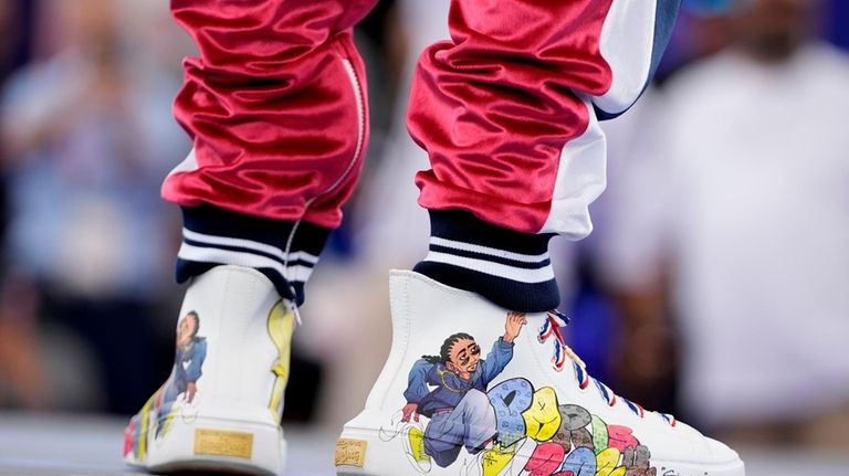 The sneakers of American artist Snoop Dogg as he performs...