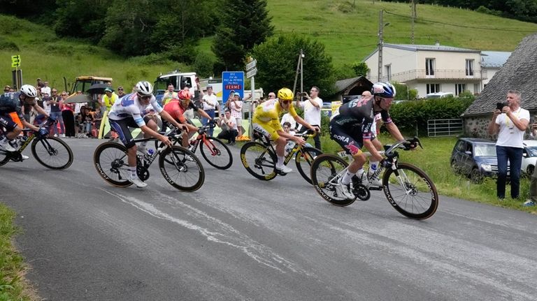 Slovenia's Primoz Roglic leads before Slovenia's Tadej Pogacar, wearing the...