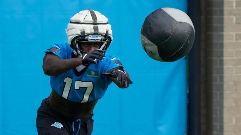 Carolina Panthers wide receiver Xavier Legette (17) runs a drill...