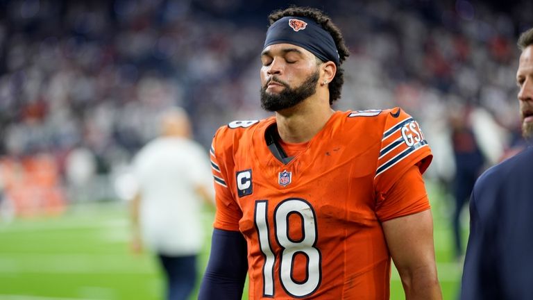 Chicago Bears quarterback Caleb Williams heads off the field following...