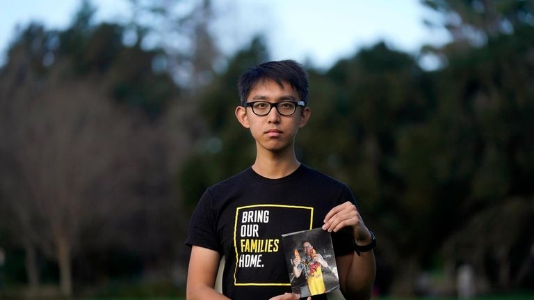 Harrison Li holds a photo of his father, Kai Li,...