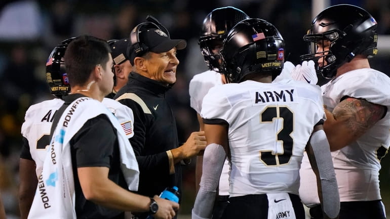 Army head coach Jeff Monken talks to his his players...