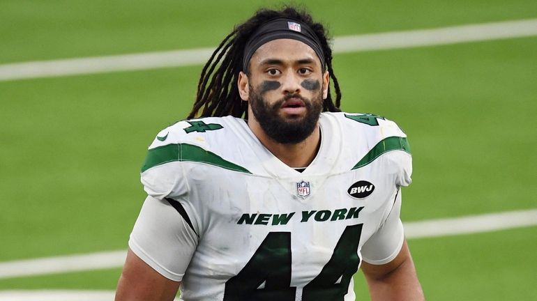 Jets linebacker Harvey Langi heads off the field after an NFL...