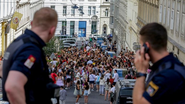 Austrian police officers watch Swifties gathering in the city centre...