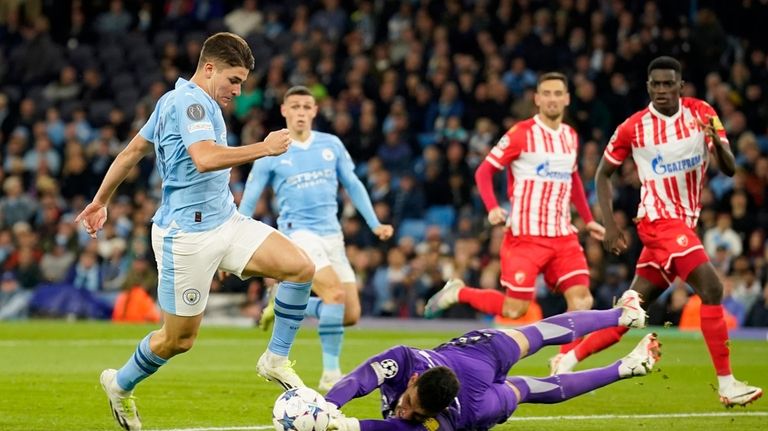 Manchester City's Julian Alvarez gets past Red Star's goalkeeper Omri...