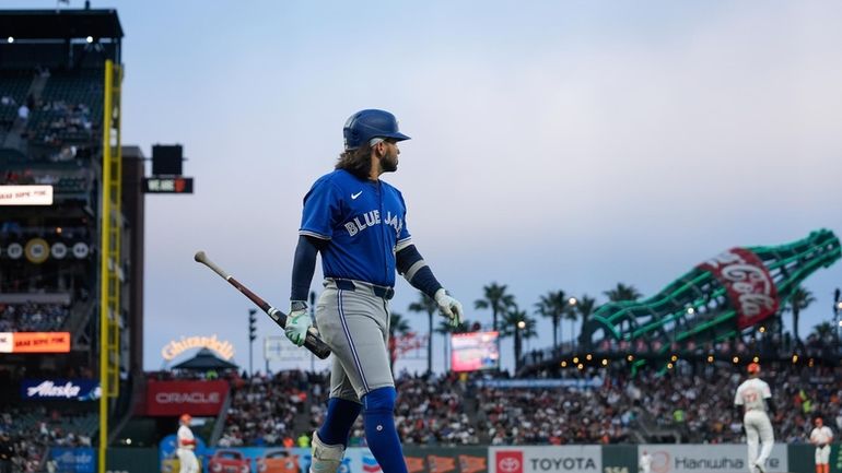 Toronto Blue Jays' Bo Bichette walks to the dugout after...