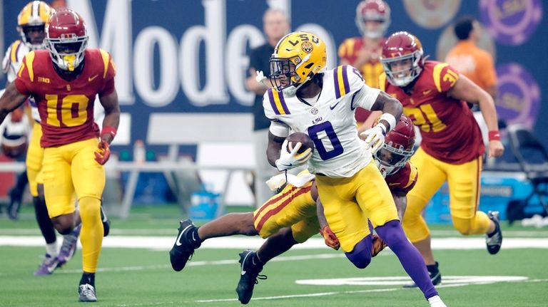 LSU wide receiver Zavion Thomas (0) avoids a tackle attempt...