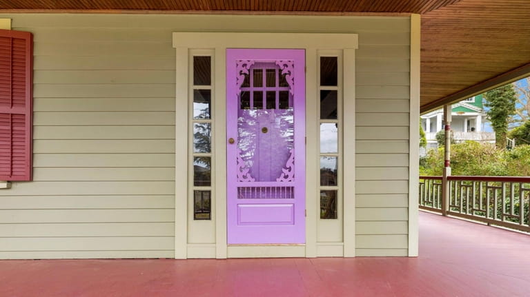 Dual wraparound porches hug the house overlooking Hempstead Bay.