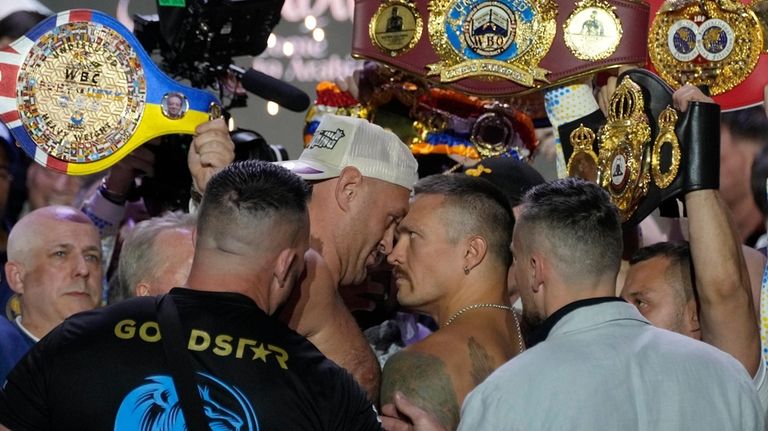 Heavyweight boxers Britain's Tyson Fury, center left, and Ukraine's Oleksandr...