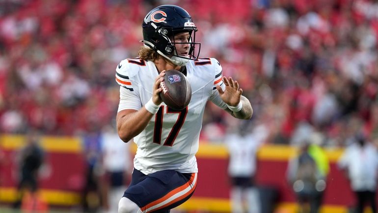 Chicago Bears quarterback Tyson Bagent scores on a touchdown run...