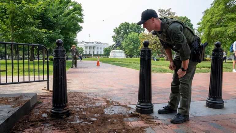 A U.S. Park Police officer inspects a security barrier for...