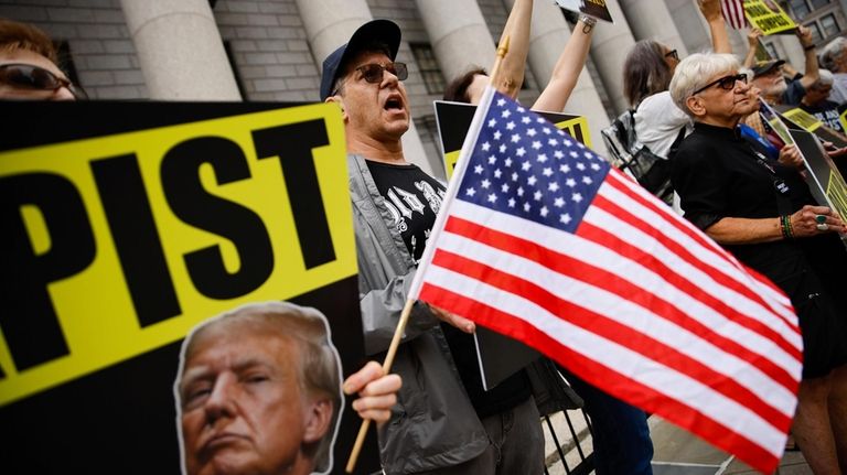 People protest against former President Donald Trump before his arrival...