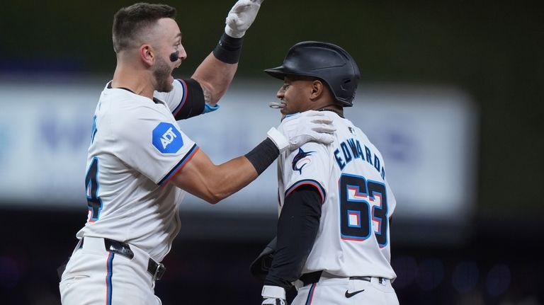 Miami Marlins third baseman Connor Norby, left, congratulates shortstop Xavier...