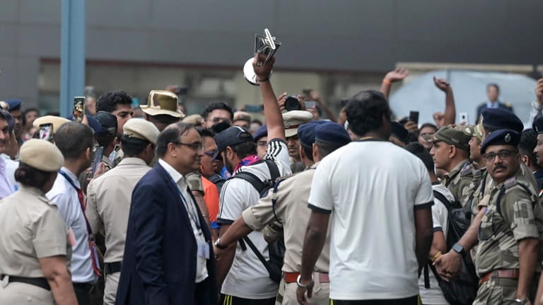 India's captain Rohit Sharma is surrounded by officials as he...