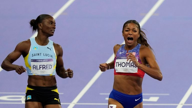 Gabrielle Thomas, of the United States, crosses the finish line...