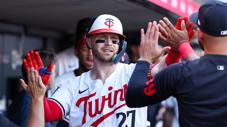 Minnesota Twins' Ryan Jeffers is congratulated for his solo home...