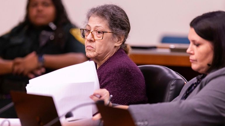 Susan Lorincz, left, listens to testimony during her trial Wednesday,...