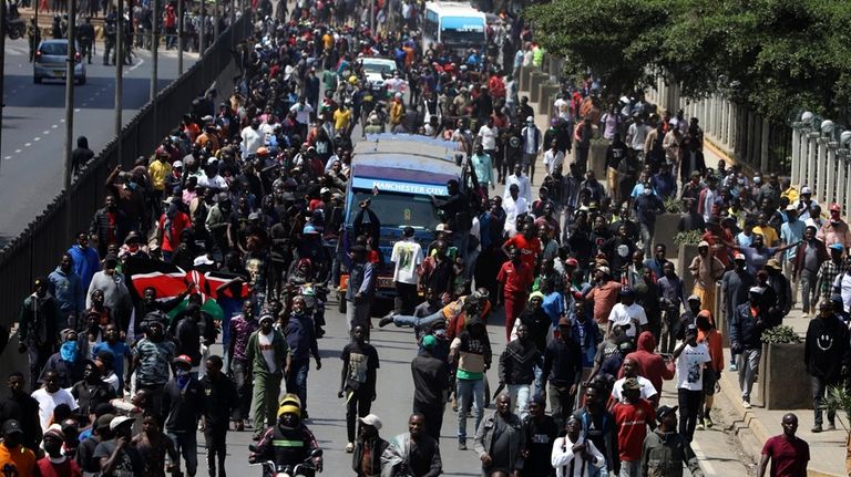 Demonstrators march during a protest in Nairobi, Kenya, Tuesday, July...