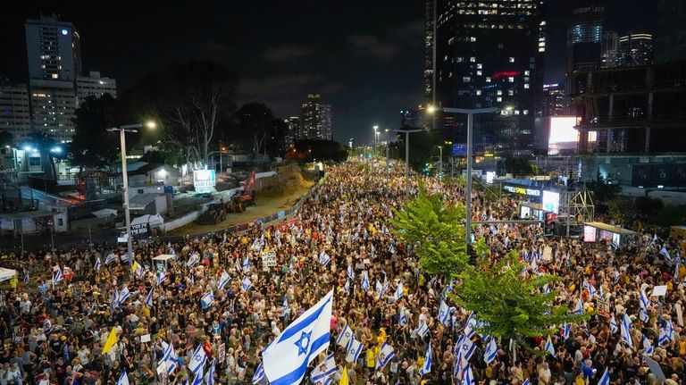 People protest against Prime Minister Benjamin Netanyahu's government and call...