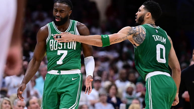Boston Celtics guard Jaylen Brown (7) is congratulated by forward...