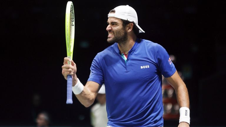 Italy's Matteo Berrettini celebrates making a point against Botic Van...