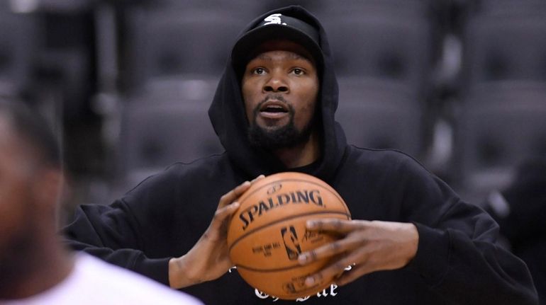 Golden State Warriors Kevin Durant watches during basketball practice at...